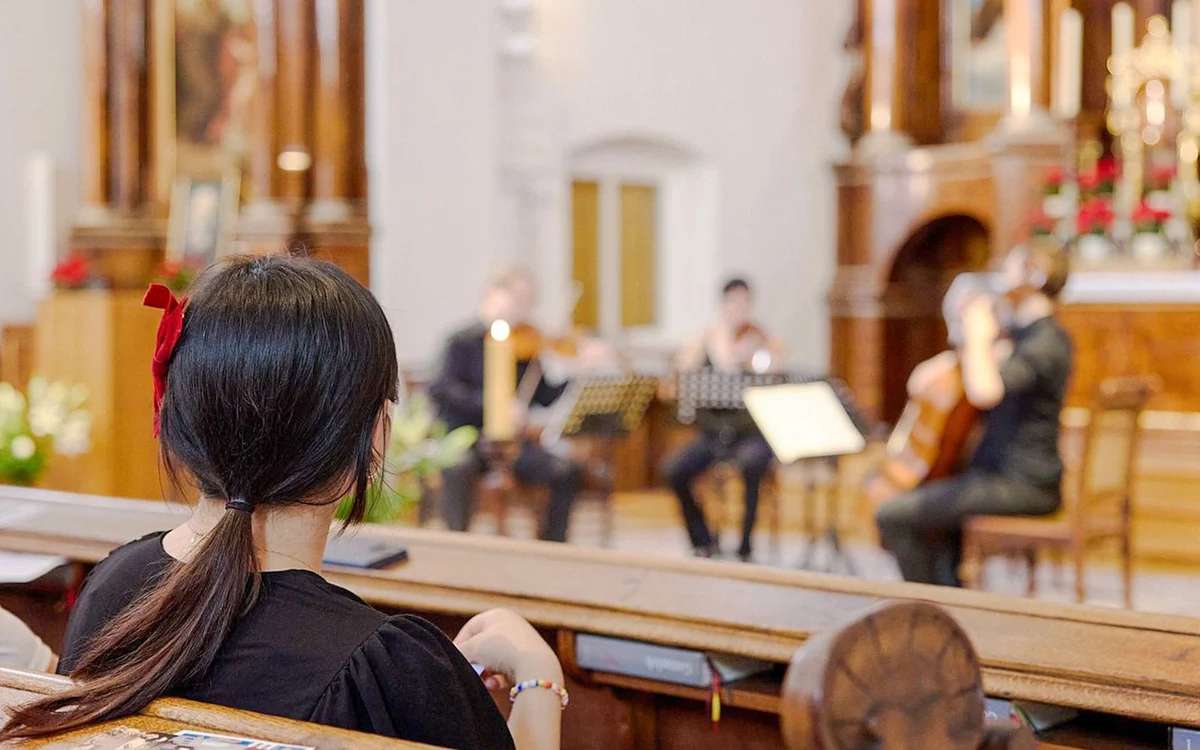 Audience member watching musicians inside the Capuchin Church