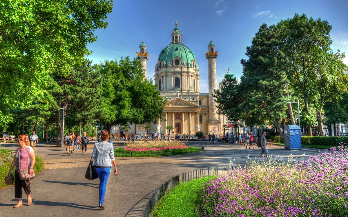 Green dome and paired columns of Karlskirche against a blue sky