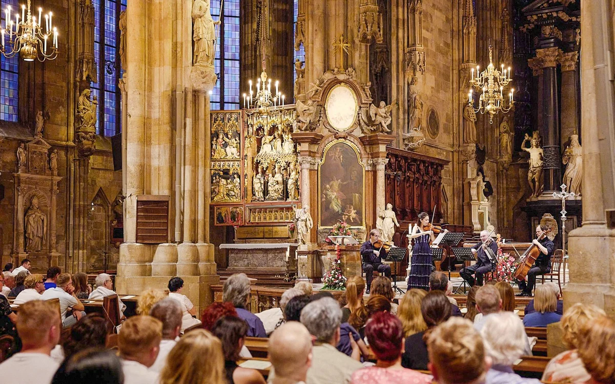 Audience and musicians beneath the ornate interior of St Stephen’s Cathedral